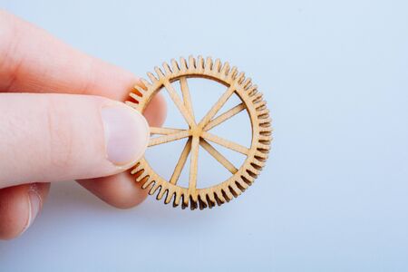 Hand holding gear wheels as the concept of mechanismの写真素材