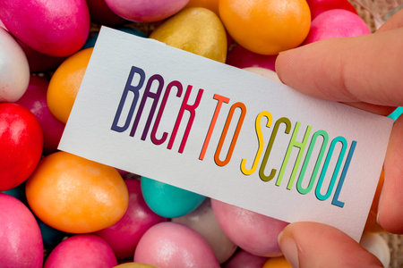 Happy Easter written on a small piece of paper on colorful decorative rocks in display