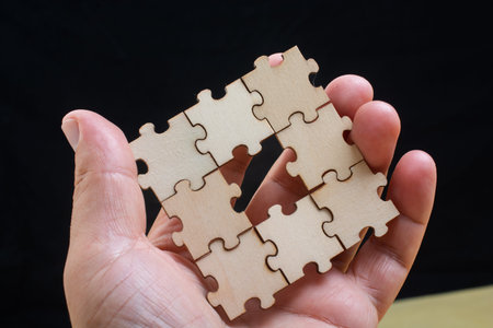 man holding last piece of jigsaw puzzle as business strategy concept