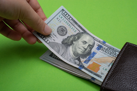 Human hand holding American dollar bill as money  banknotesのeditorial素材