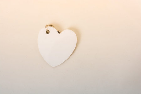 Heart shaped white object in view on the white background
