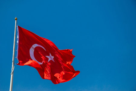 Turkish national flag with white star and moon in sky