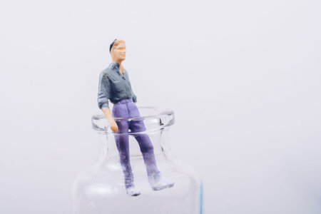 Tiny figurine of man miniature model coming out of bottle