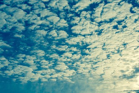 Grey color clouds partly cover the sky in the daytimeの写真素材