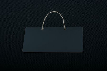 Rectangular shaped black notice board on black backgroundの写真素材