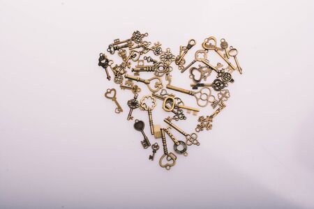 Retro  metal keys form a heart shape on whiteの写真素材
