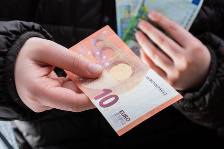 Hands giving  euro banknotes currencies as  financial activity