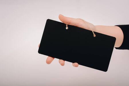 Rectangular shaped black notice board in hand on white backgroundの写真素材