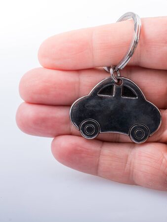 automobile business concept with a metal car icon in handの写真素材