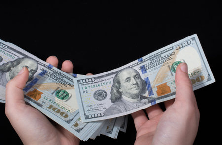 Hand holding American dollar  banknotes isolated on white background