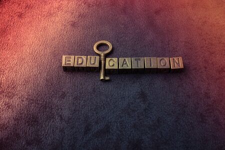 Retro styled decorative key and education wording on dark backgroundの写真素材