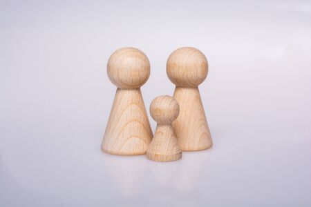 Wooden figurines of  family as concept of caring for childrenの写真素材