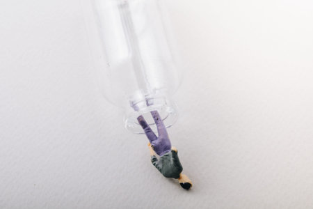 Tiny figurine of man miniature model coming out of bottle