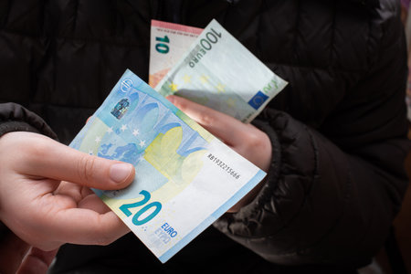 Hands giving  euro banknotes currencies as  financial activity
