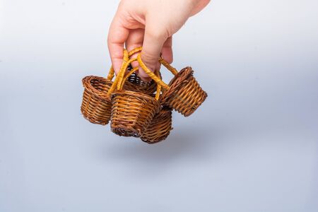 Hand holding Little size Empty wicker basketsの写真素材
