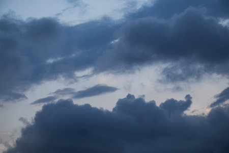 Grey color clouds partly cover the sky in the daytime