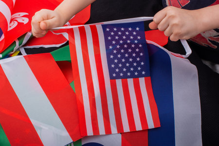 Child hand holding an American national flag in hand
