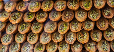Turkish traditional dessert Kadayif  baked in syrup served with nut powder