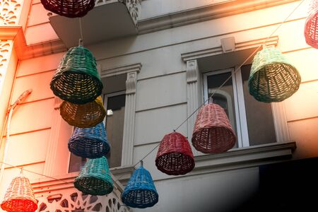 Empty wicker baskets used as decorative lamps in the streetの写真素材