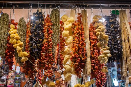 Dried eggplants peppers and vegetables hanging up at Turkish groceryの写真素材