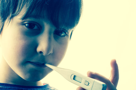 measuring Fever temperature.  Child with thermometer.  World pandemic concept.