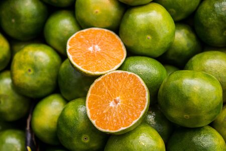 Freshly picked green tangerines mandarines, clementines, as Citrus fruit background.の写真素材