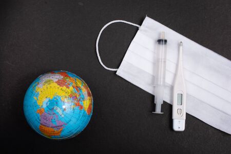 Coronavirus 2019 Pandemic.  World epidemic concept. Mask,  globes,  gloved, syringe,の写真素材