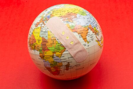 earth with bandage Solidarity and aid to countries in need conceptの写真素材