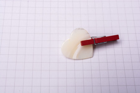White heart icon  on checked paper for love  and valentine concept