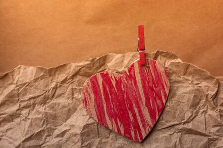 Red heart icon  on wrinkled paper for love  and valentine conceptの写真素材