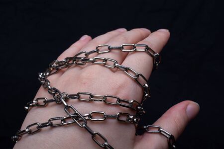 A female's hand wrapped in a chainの写真素材