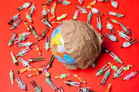 Figurines around globe as death toll. Coronavirus pandemic in world.の写真素材