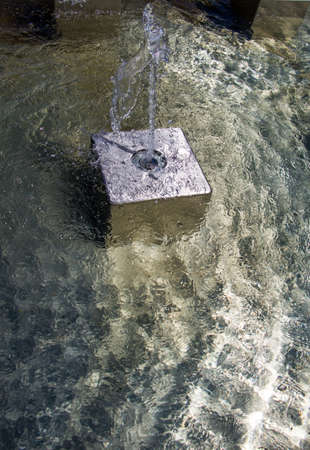 The fountains gushing sparkling water in a pool in a parkの写真素材