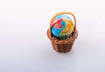 Little model globe in a basket in viewの写真素材