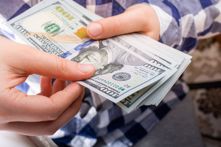 Hands holding USD dollar  banknotes currencies as  financial activity