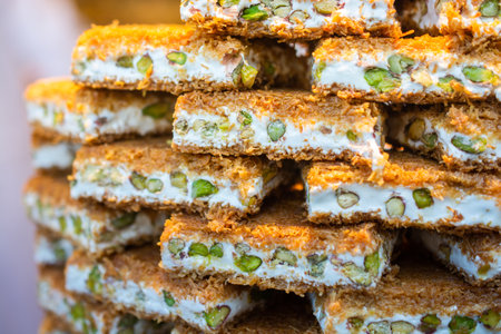 Turkish traditional dessert Kadayif  baked in syrup served with nut powderの写真素材