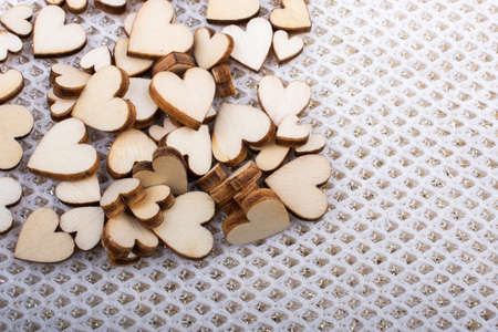 Wooden hearts form a round shape on white backgroundの写真素材