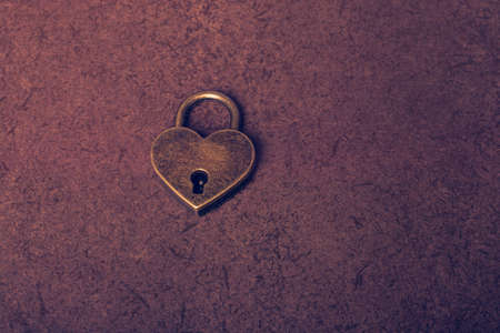 Metal padlock in heart shape as  symbol of loveの写真素材