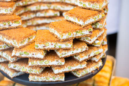 Turkish traditional dessert Kadayif  baked in syrup served with nut powderの写真素材