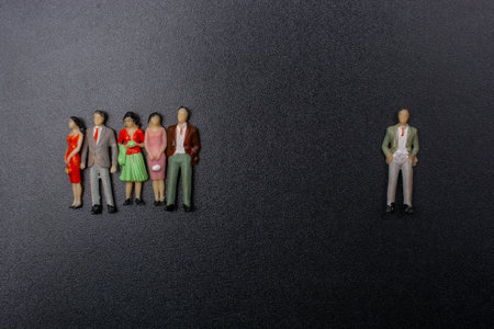 Miniature people stay apart to reduce Covid 19 infection.  Healthcare concept