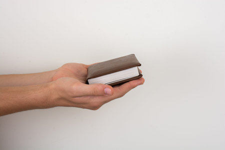 White notebook in hand on  a white color background