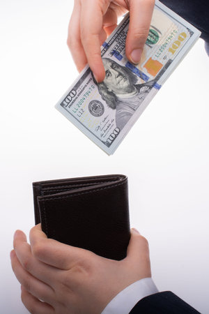 Businessman with dollar banknotes and  wallet on white background