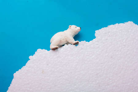 Fake Polar bear cub  on fake snow and sea background environmentの写真素材