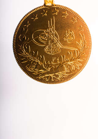 Turkish Ottoman style gold coin on white backgroundの写真素材