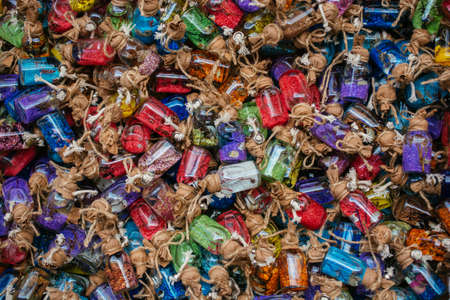 set of small glass decorative bottles with various colorful sandの写真素材