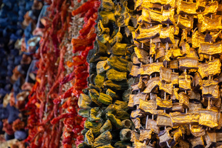Dried eggplants peppers and vegetables hanging up at Turkish groceryの写真素材