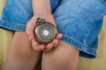 Child holding a Magnetic compass tool as a concept of traveling