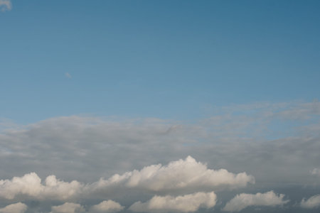 Grey color clouds partly cover the sky in the daytime