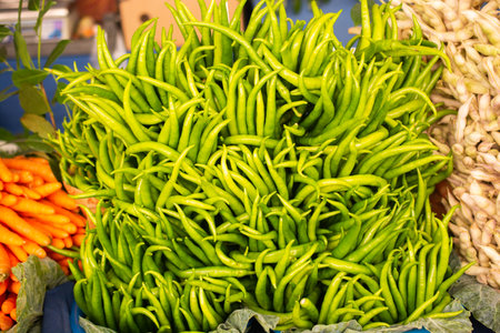 A Lot of green Chilli Peppers found as food backgroundの写真素材