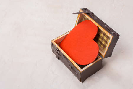 Heart shape icon in a suitcase as love and romance conceptの写真素材